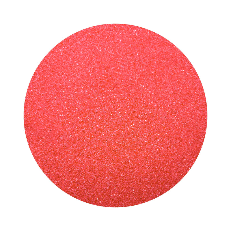 red colored sand arranged in a circular shape on a white background