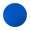 Royal Blue colored sand arranged in a circular shape on a white background