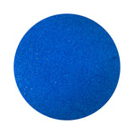 Royal Blue colored sand arranged in a circular shape on a white background
