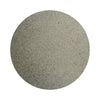 Gray colored sand arranged in a circular shape on a white background
