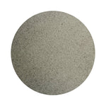 Gray colored sand arranged in a circular shape on a white background