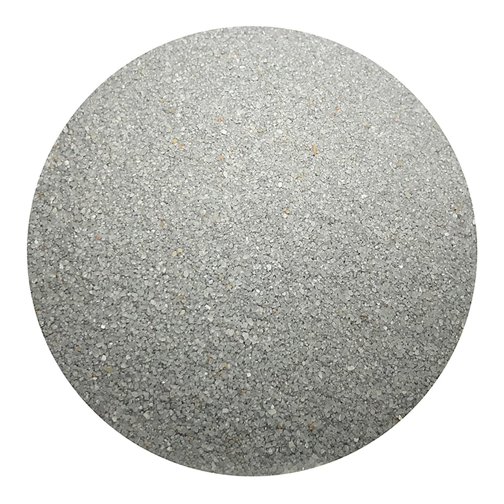 silver colored sand arranged in a circular shape on a white background